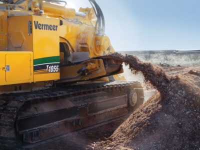 A Vermeer T1055 machine pushes out dirt in a surface mine