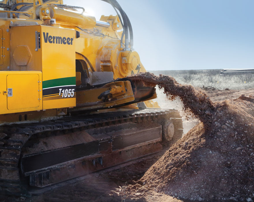 A Vermeer T1055 machine pushes out dirt in a surface mine