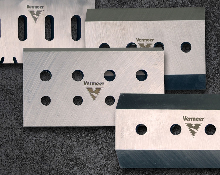 A graphic with multiple overlaid brush chipper knives engraved with the Vermeer logo.
