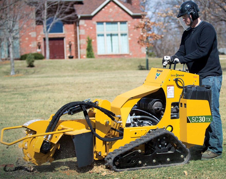 A man operates a SC30TX stump cutter from the machines controls