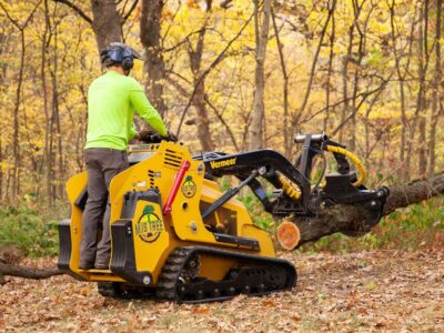 A man operating a mini skid steer