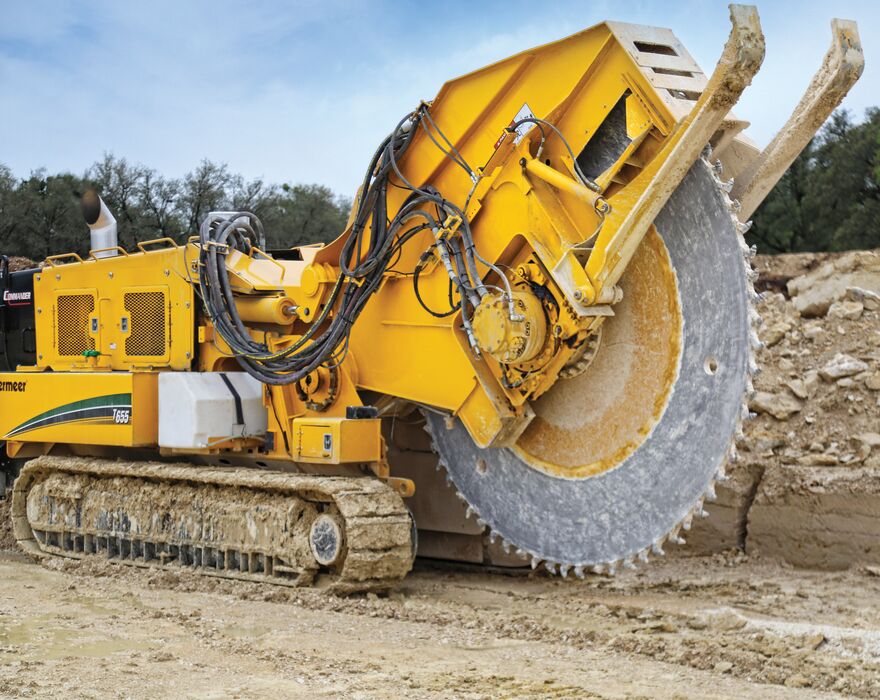 A large yellow trencher with a rockwheel attachment