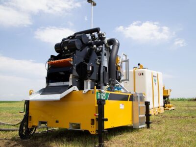 A reclaimer sits behind a mix system in a field