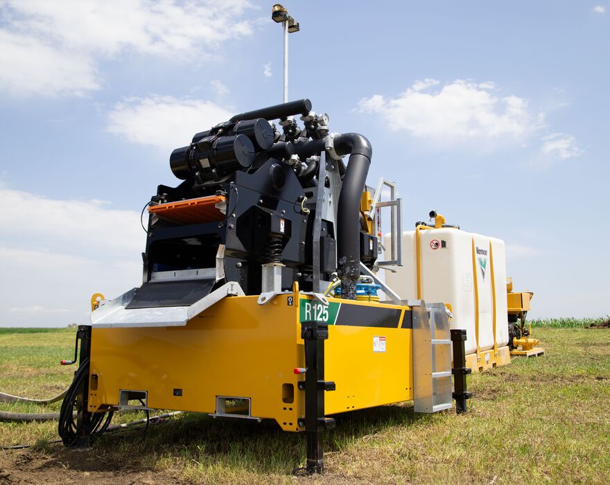 A reclaimer sits behind a mix system in a field